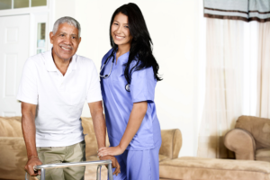 old man and his caregiver standing in the living room
