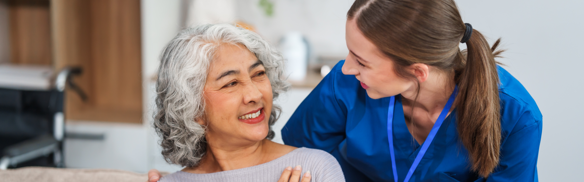 Female caregiver having fun with elder woman