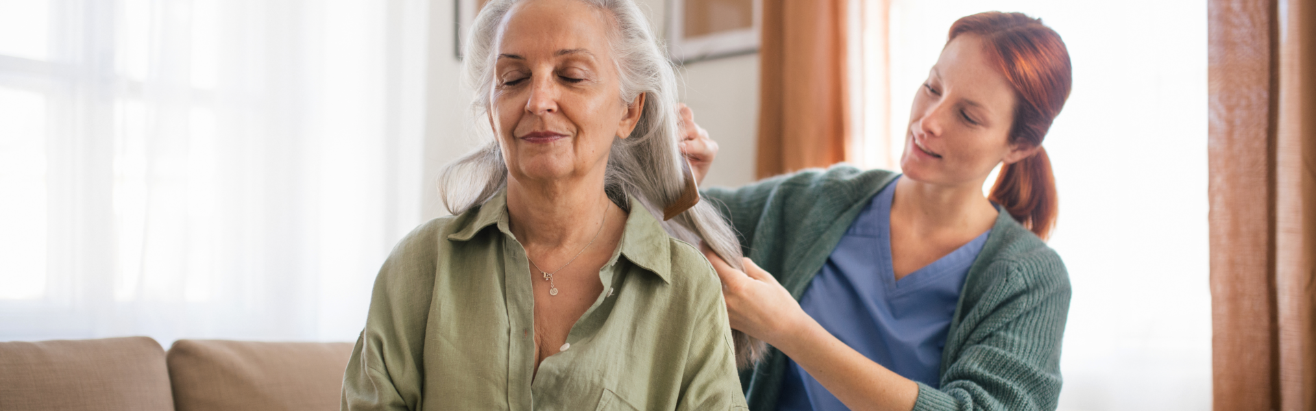 Female Caregiver brush the hair of elder woman